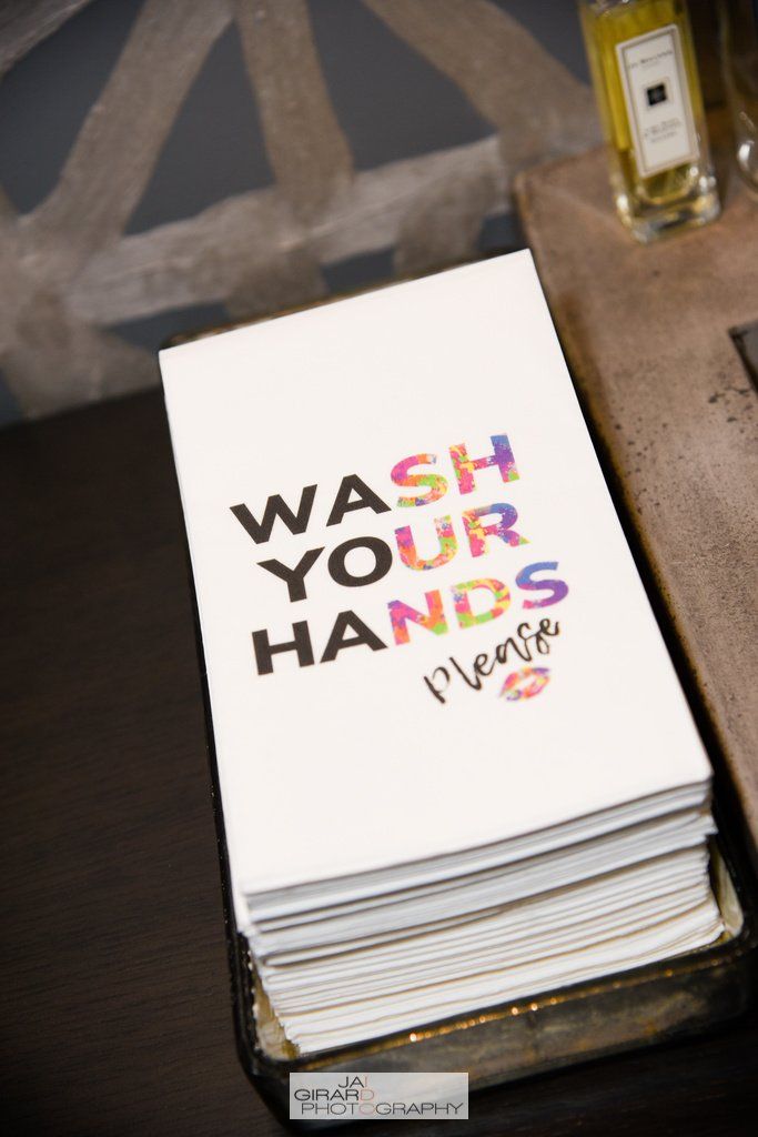 A stack of napkins that say wash your hands