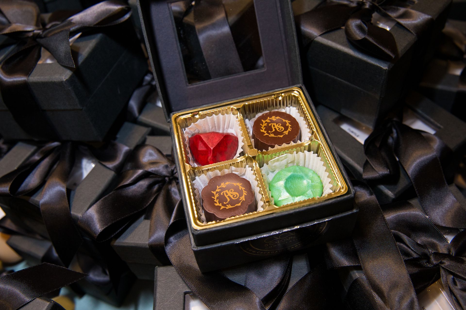 A box filled with four different colored chocolates