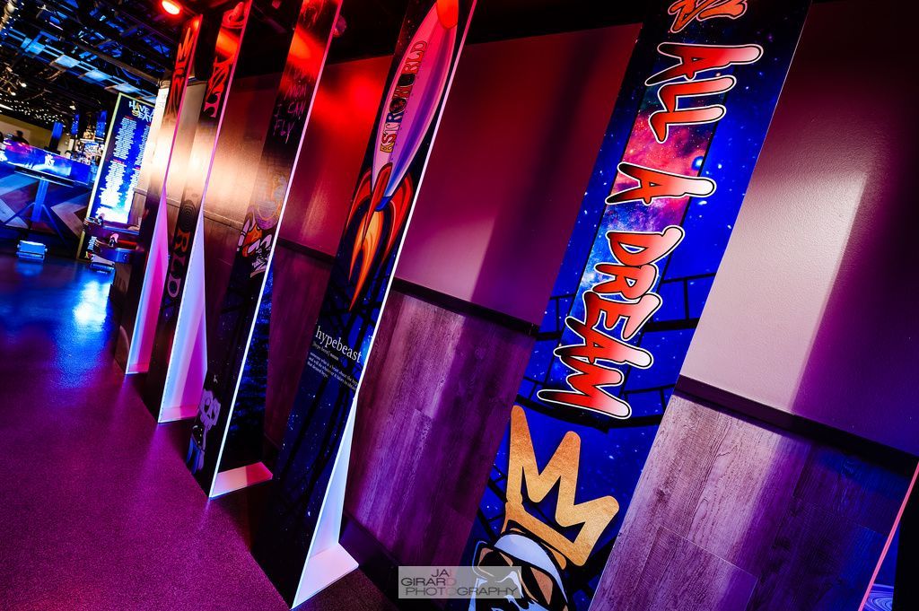 A row of posters hanging on a wall with one that says ' king ' on it