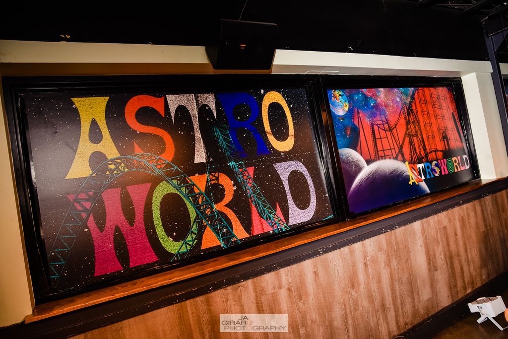 There is a painting on the wall that says astro world.