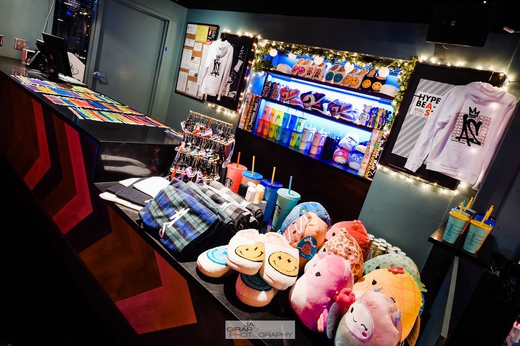 A bunch of stuffed animals are sitting on a counter in a store.