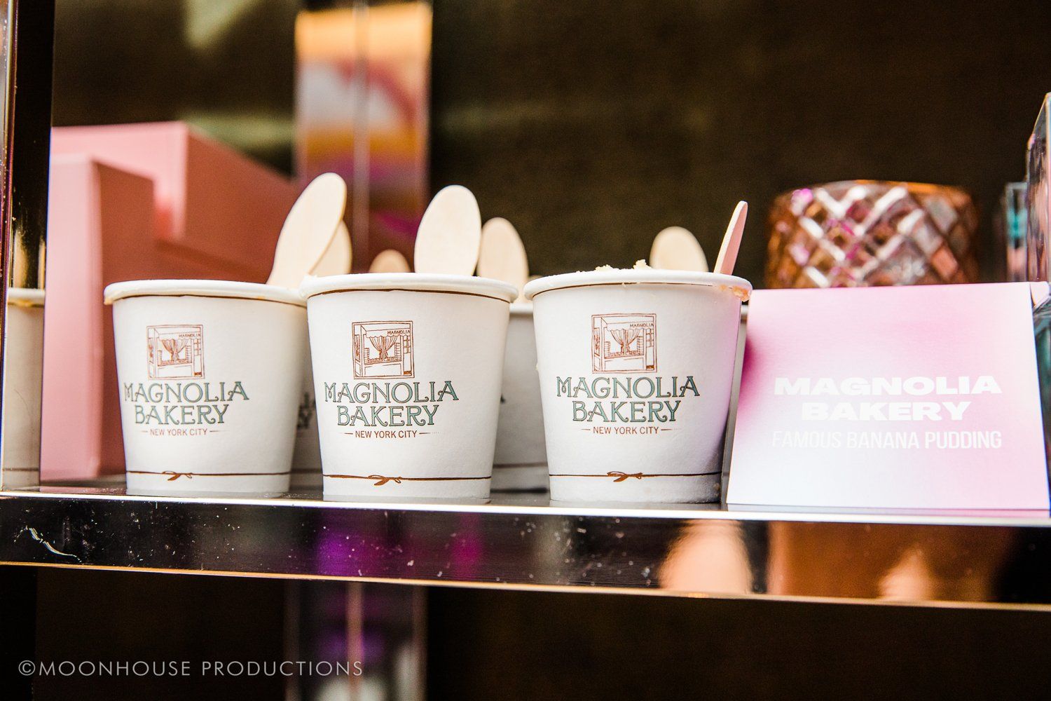 Three cups of magnolia bakery ice cream on a shelf