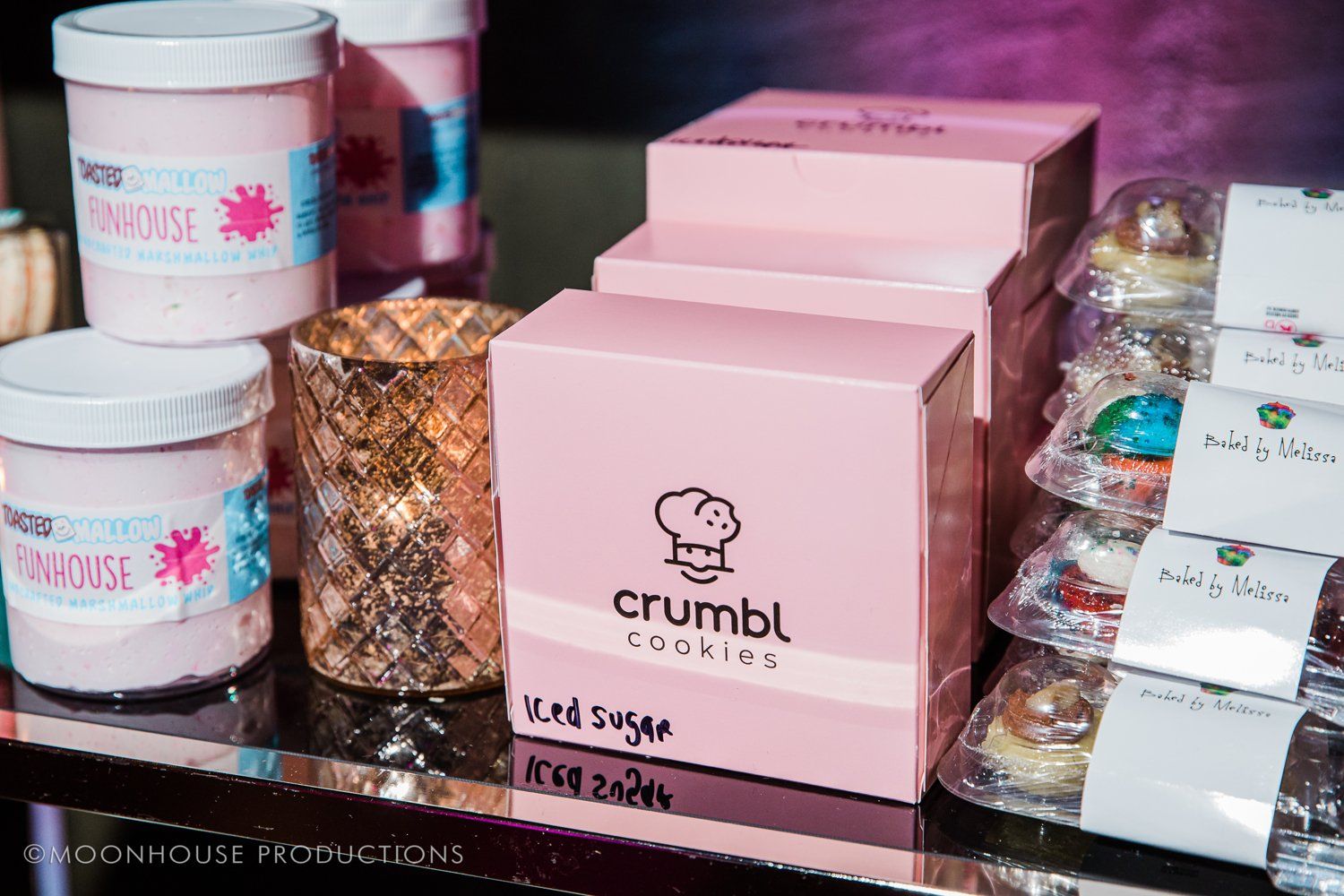 A stack of pink boxes sitting on top of each other on a table.