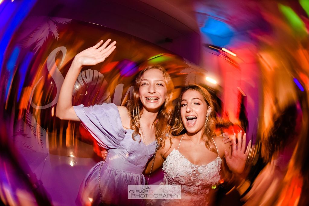 Two women are posing for a picture at a party.