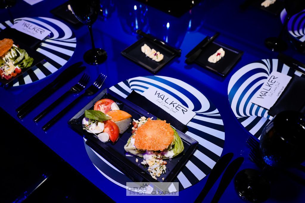 Plates of food on a table with a blue background