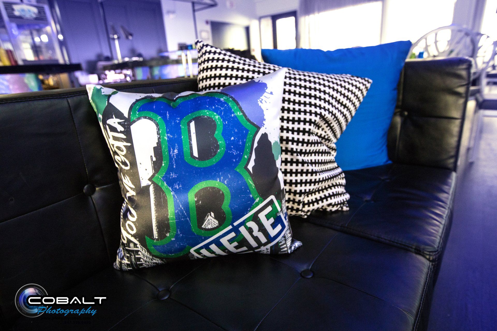 A couch with a pillow that says ' i 'm here ' on it