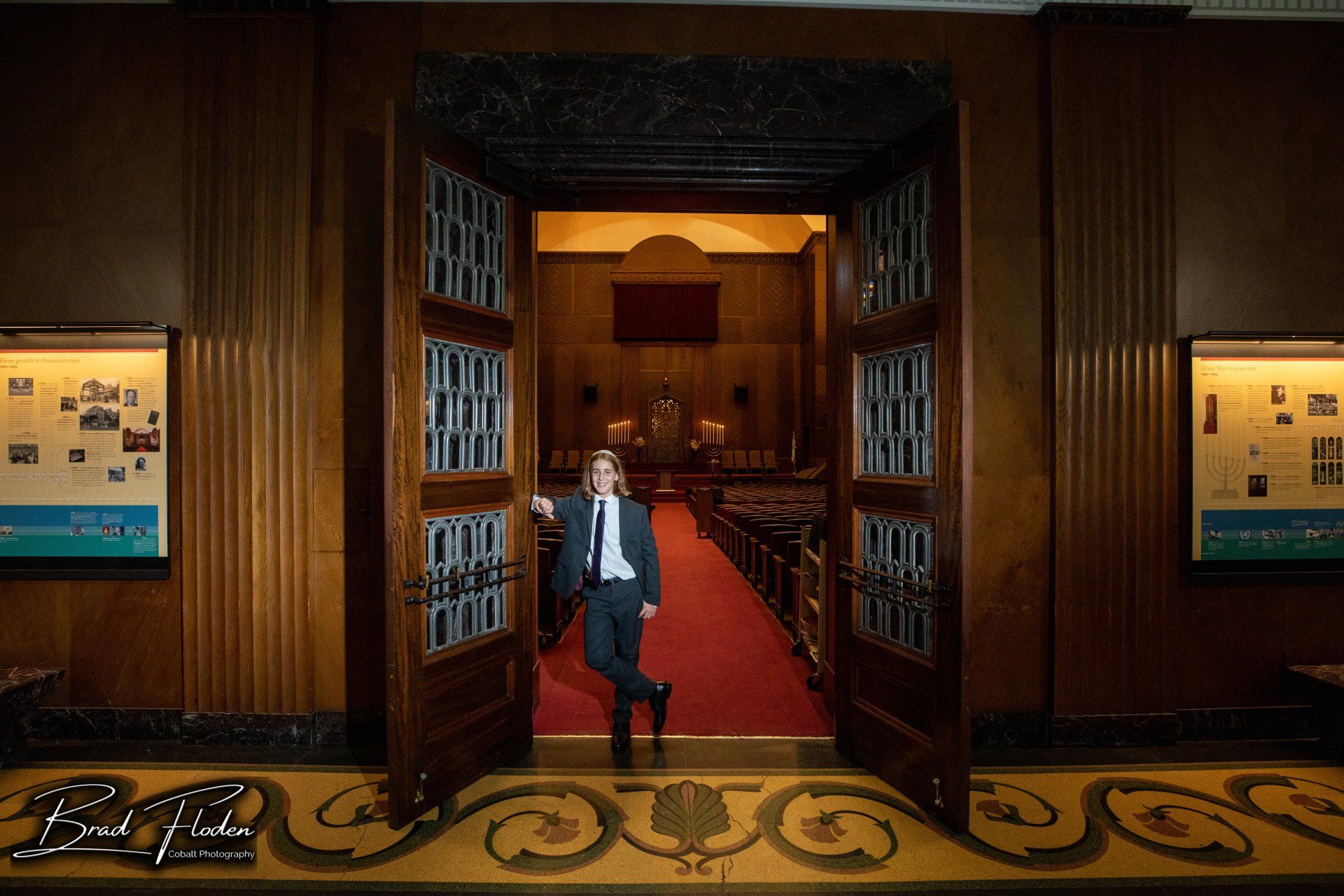 A man in a suit and tie is standing in the doorway of a church.