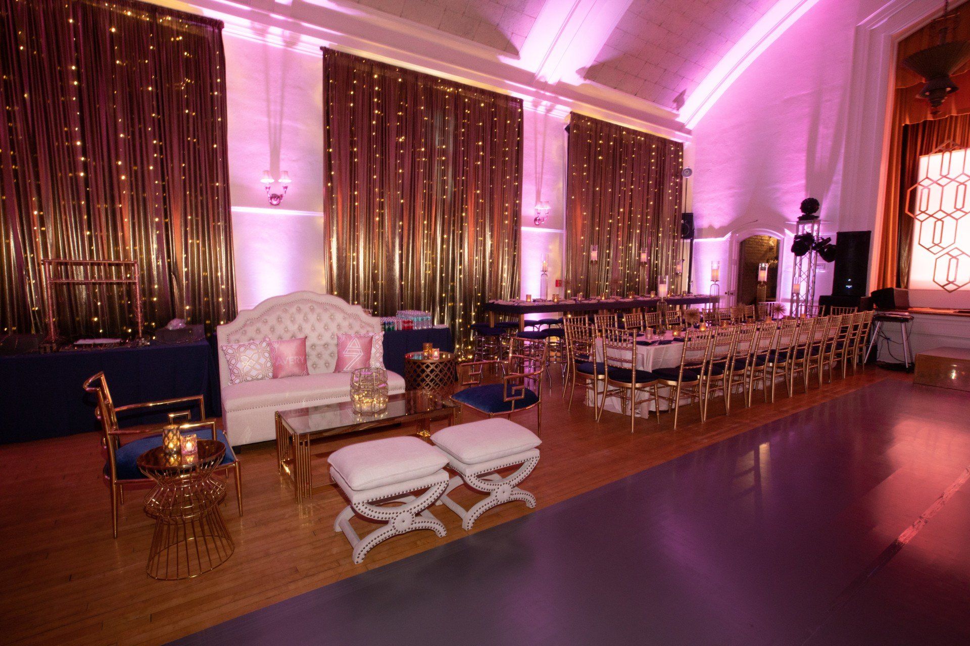 A large room filled with furniture and tables and a dance floor.
