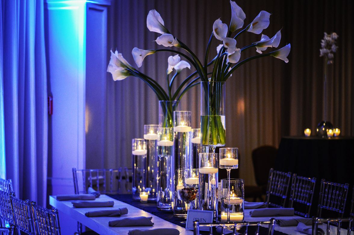A long table with candles and flowers on it.