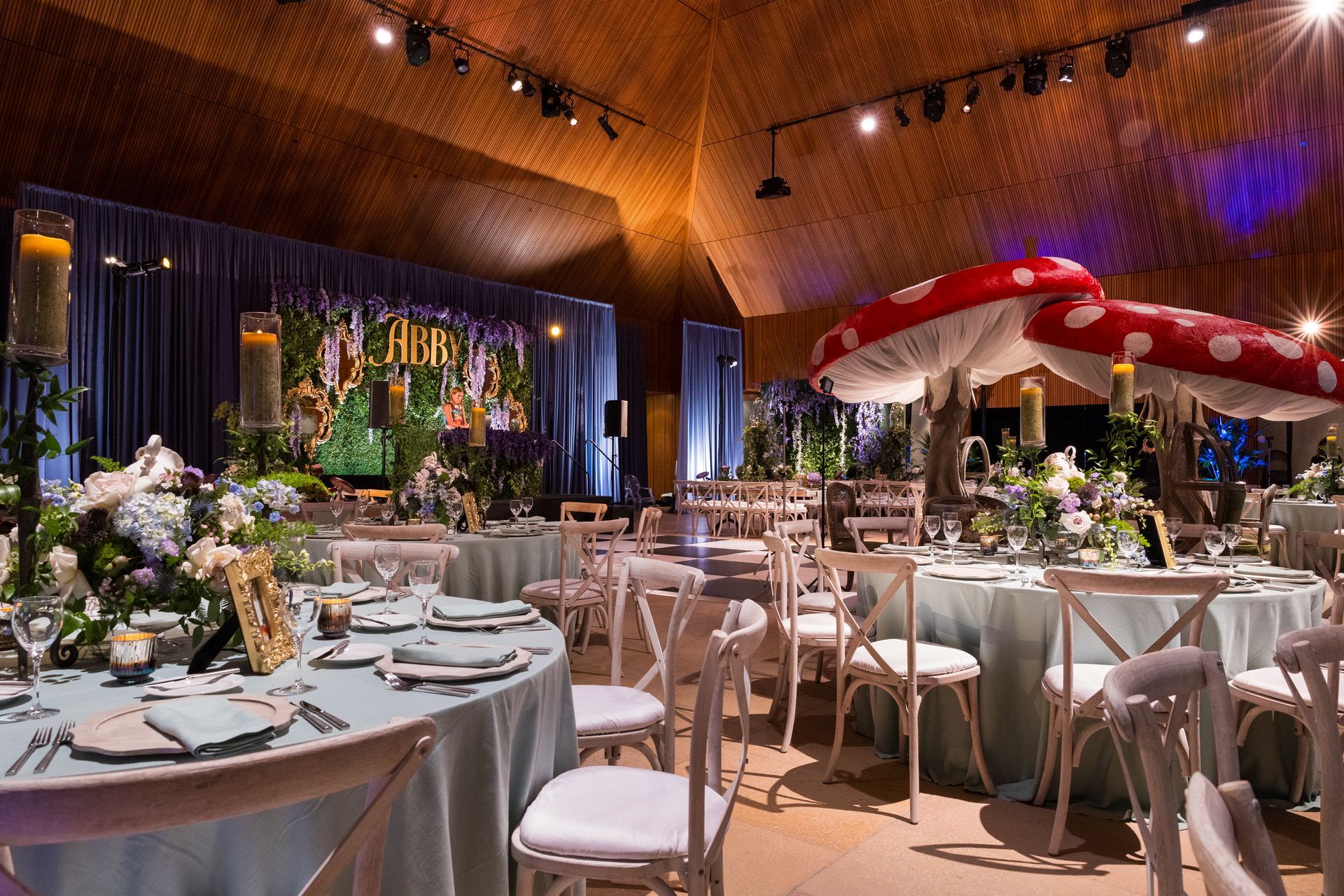 A large room with tables and chairs set up for a party.