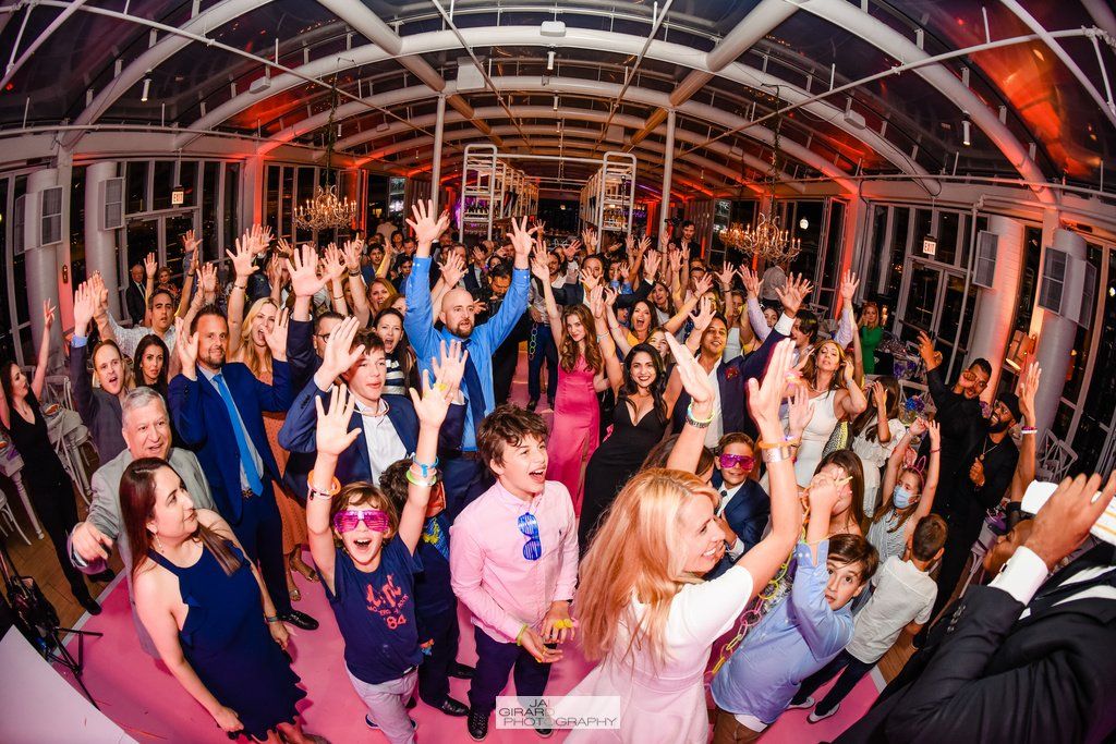 A large group of people are dancing at a party.