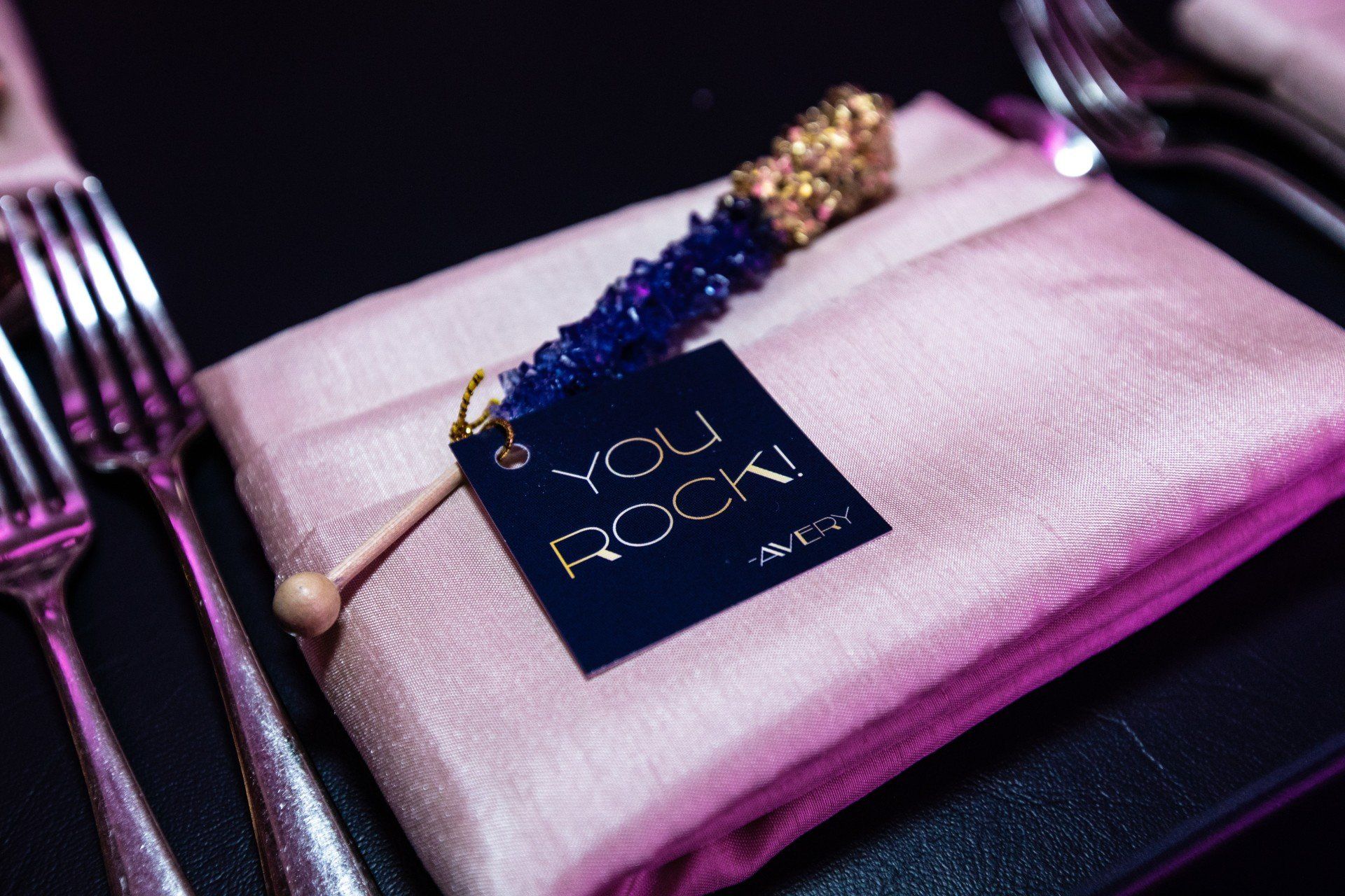 A pink napkin with a tag that says `` you rock '' on it.