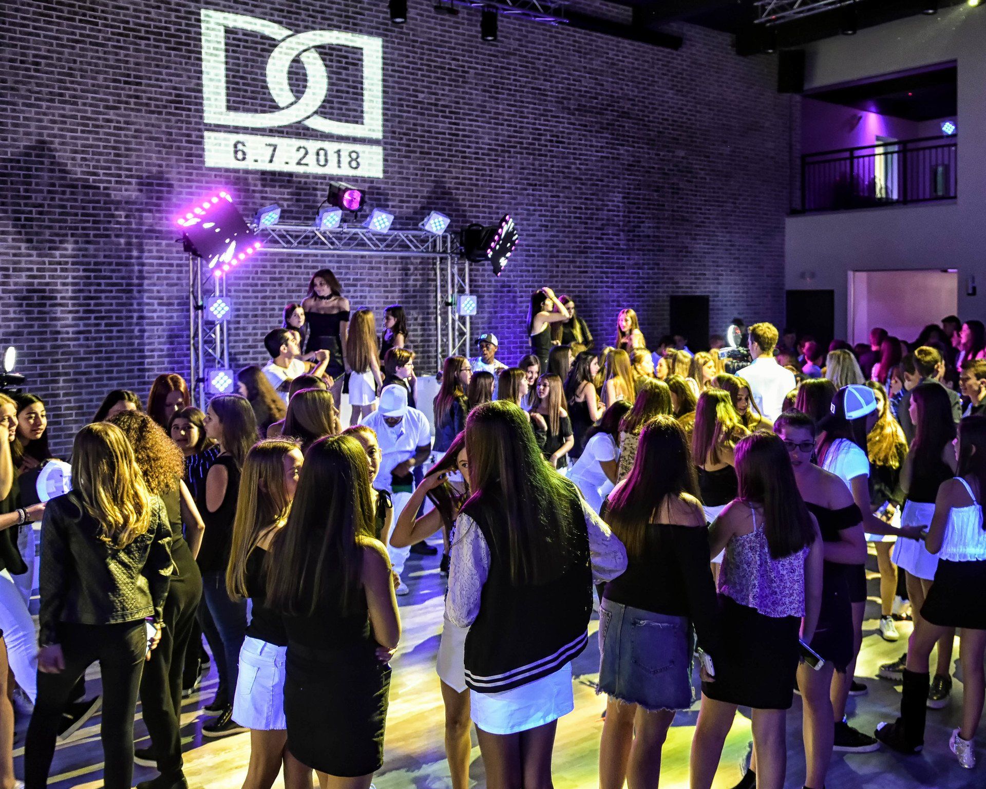 A large group of people are dancing at a party.