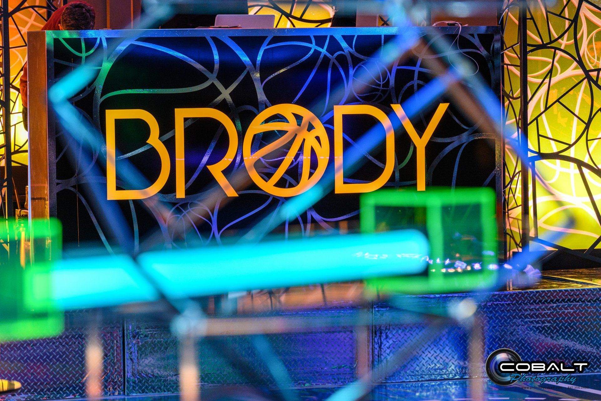 A neon sign that says brody on it