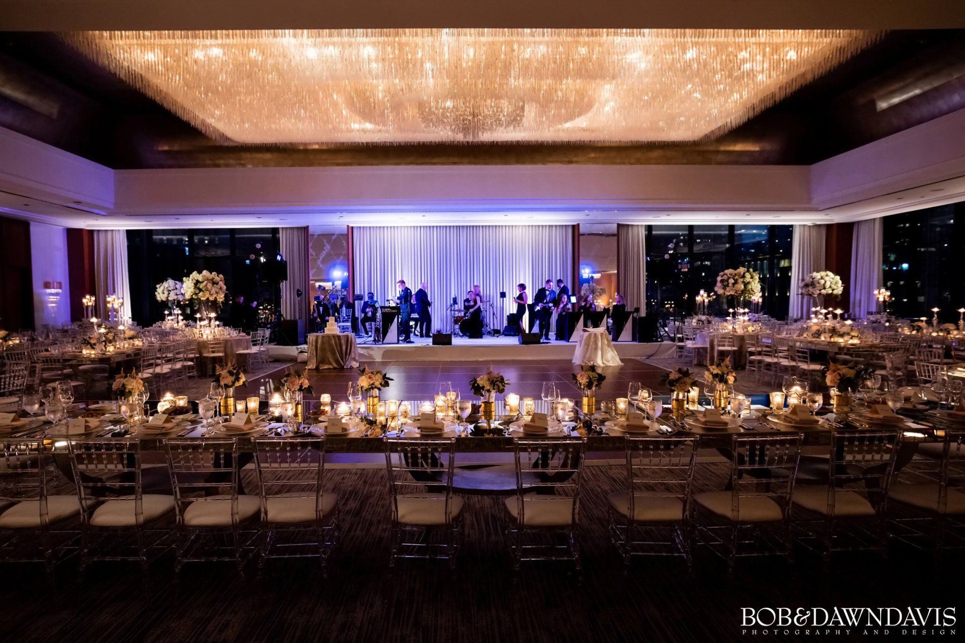 A large room with tables and chairs set up for a wedding reception.