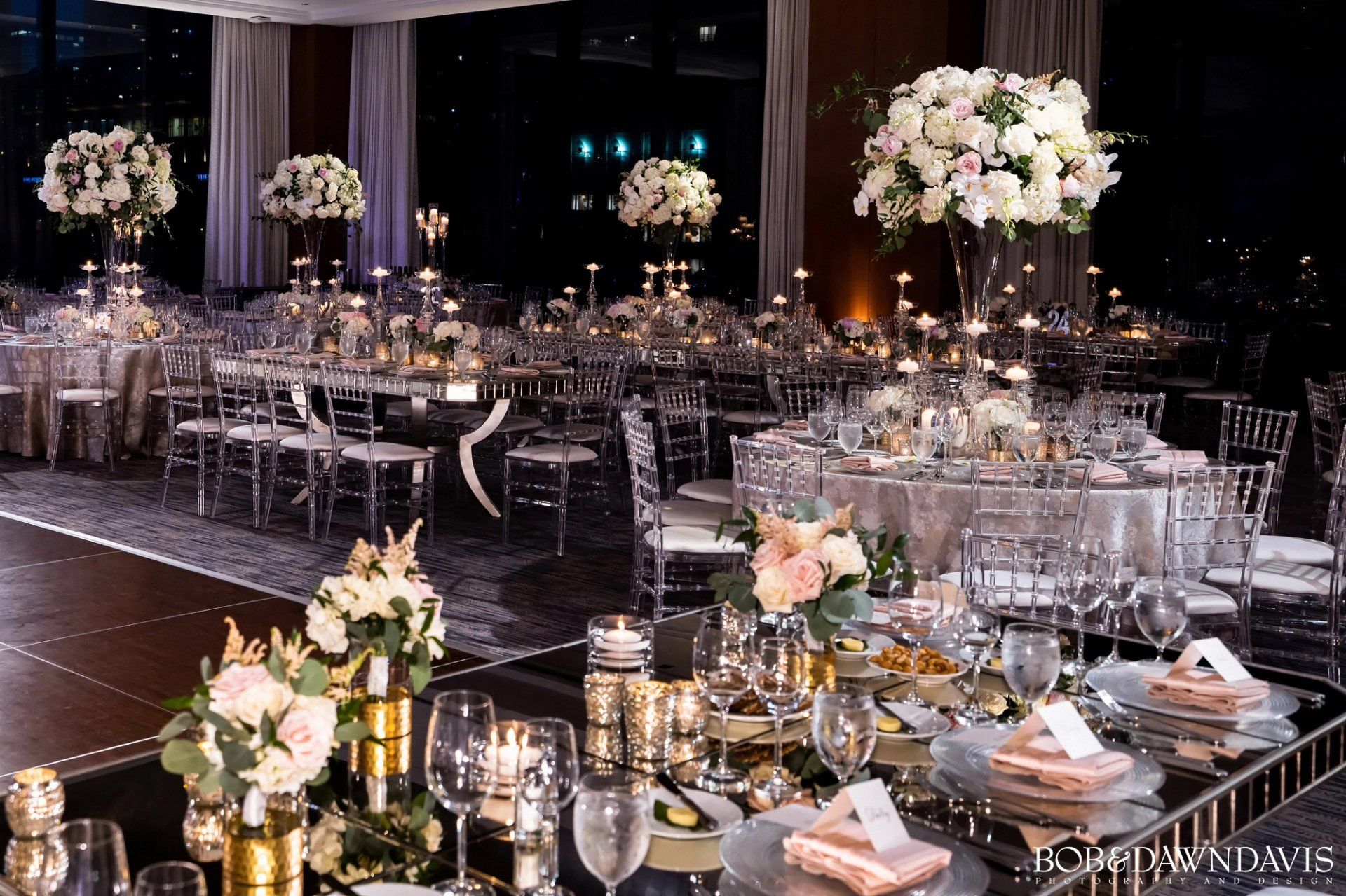 A large room with tables and chairs set up for a wedding reception.