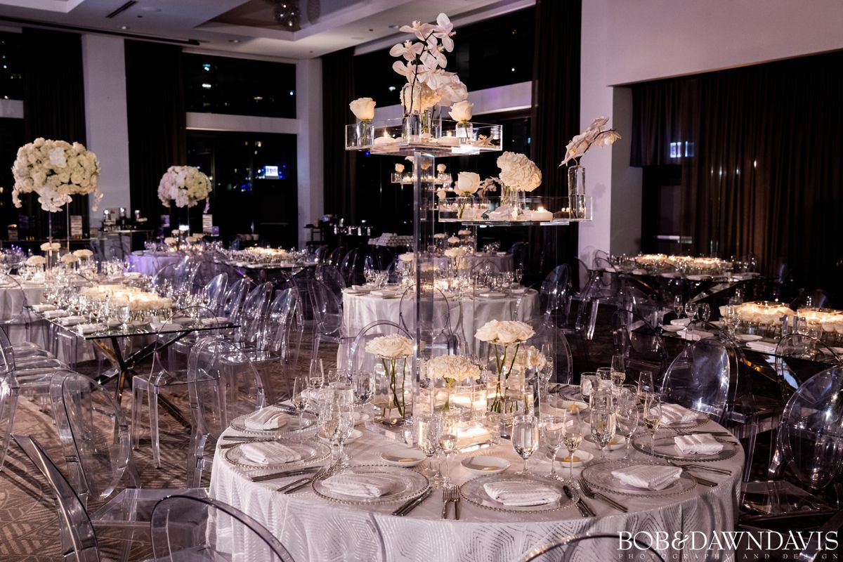 A large room with tables and chairs set up for a wedding reception.