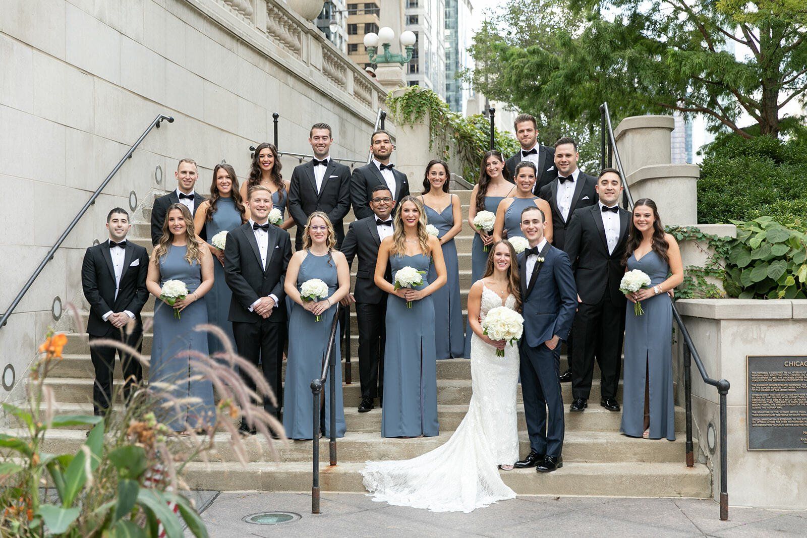 A large group of people are posing for a picture on a set of stairs.