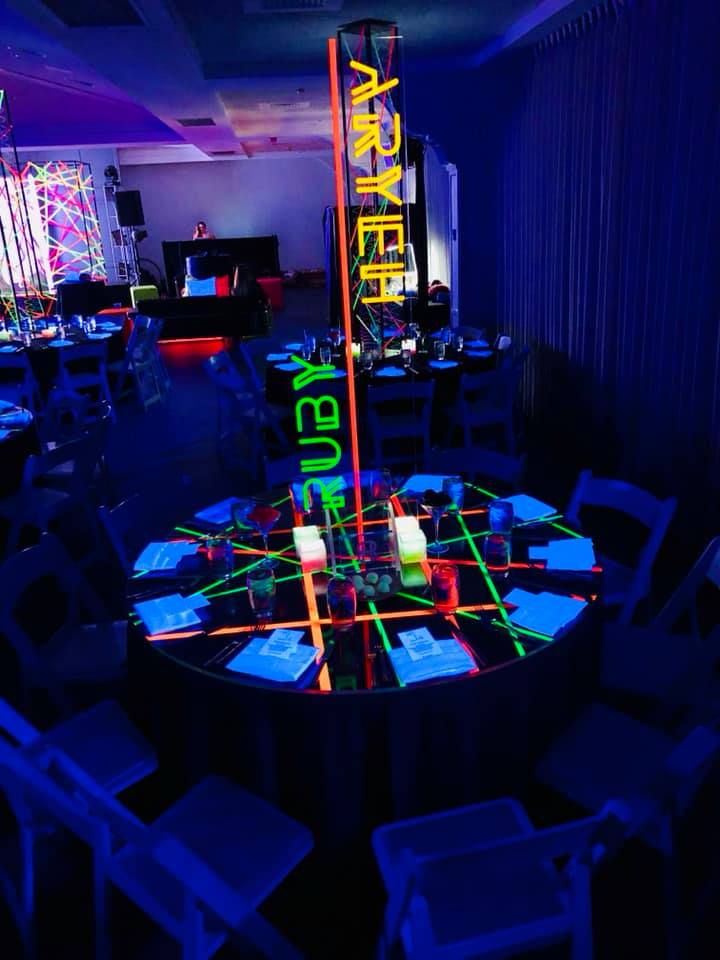 A table with a neon sign that says ruby on it