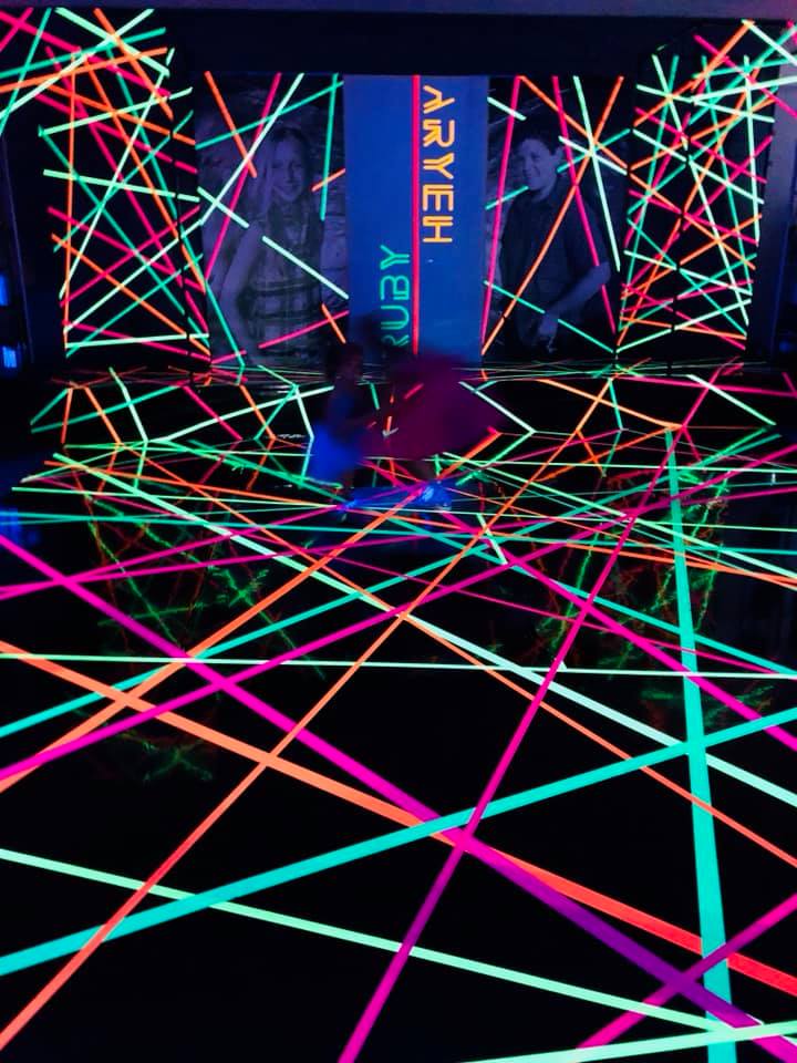 A glow in the dark room with a sign that says aeon