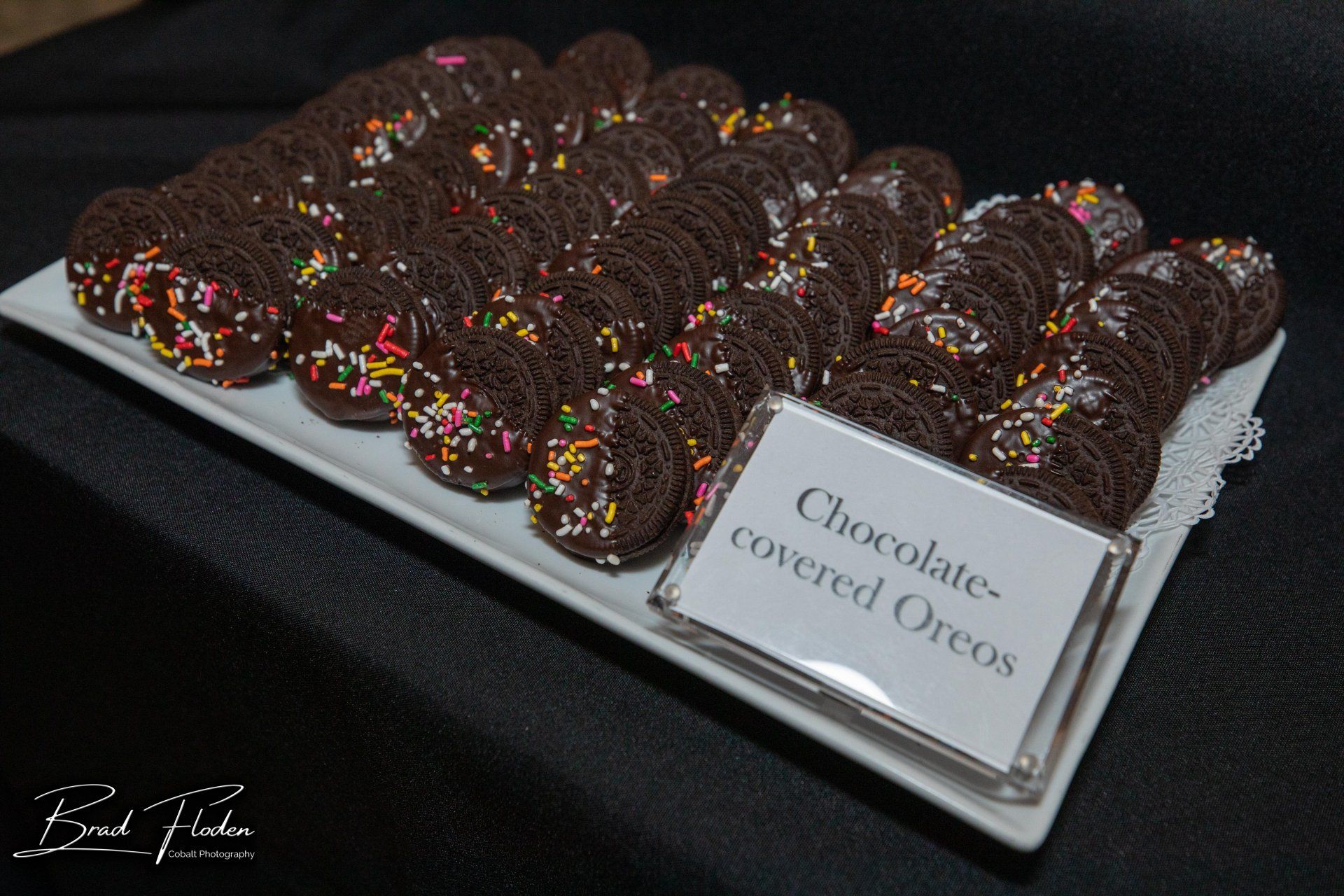A tray of chocolate covered oreos with sprinkles