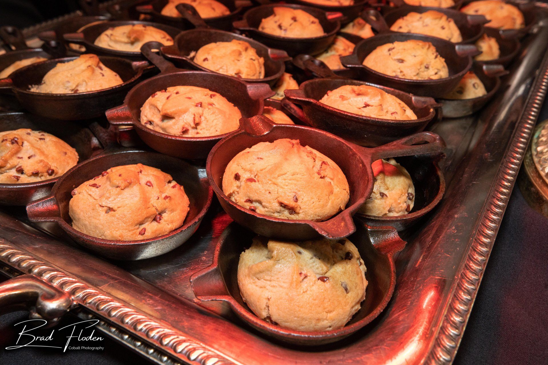 A tray of chocolate chip cookies in skillets on a table