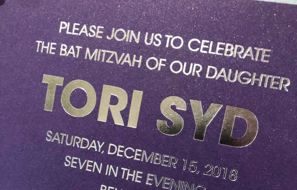A purple card that says please join us to celebrate the bat mitzvah of our daughter tori syd