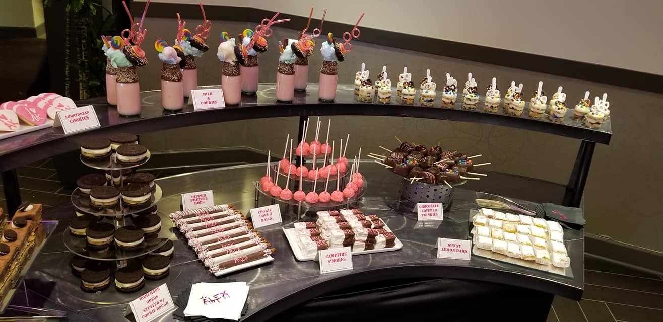 A buffet table with a variety of desserts on it