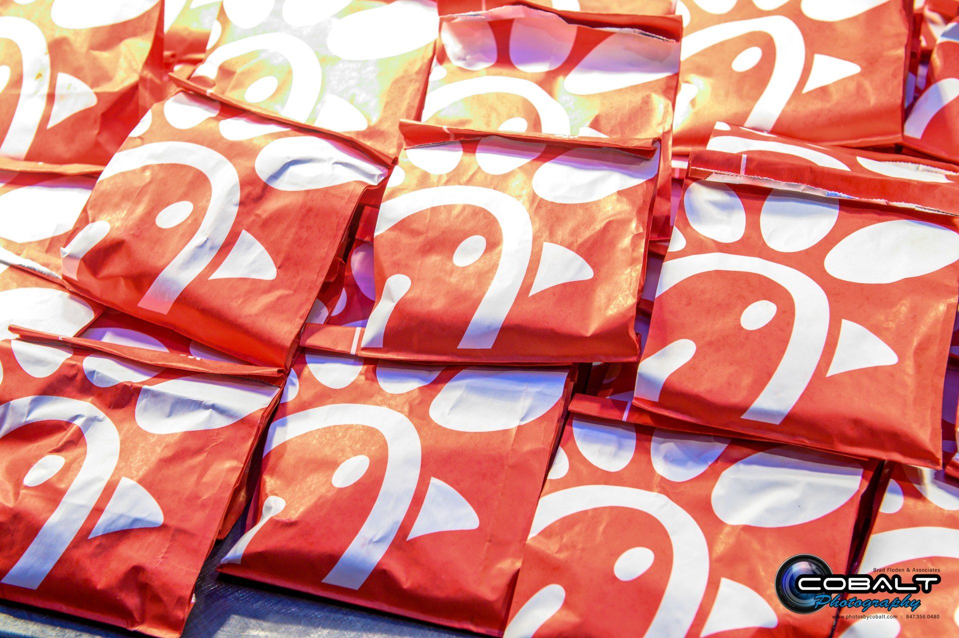 A bunch of chick fil a bags are stacked on top of each other