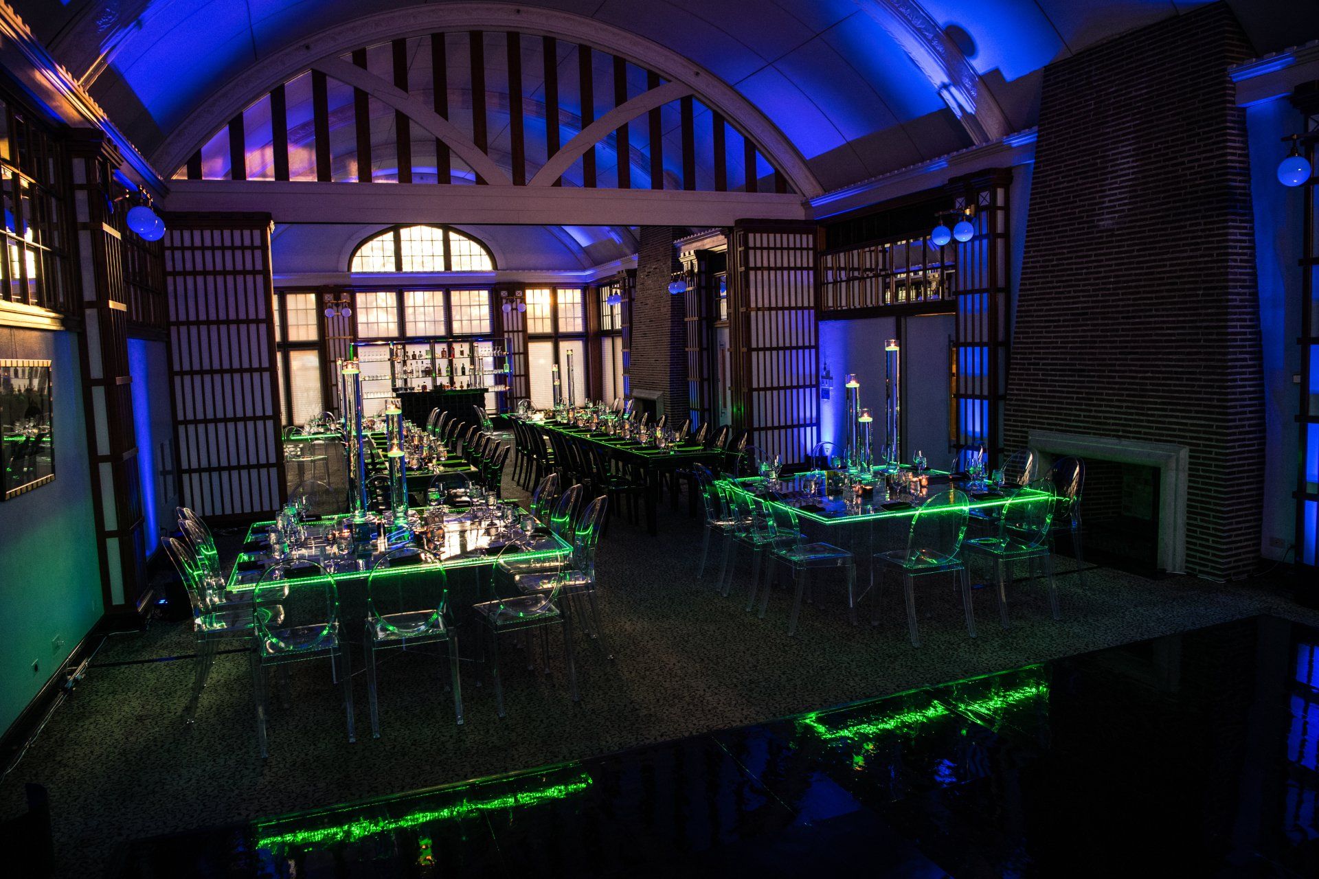 A large room with tables and chairs set up for a party.