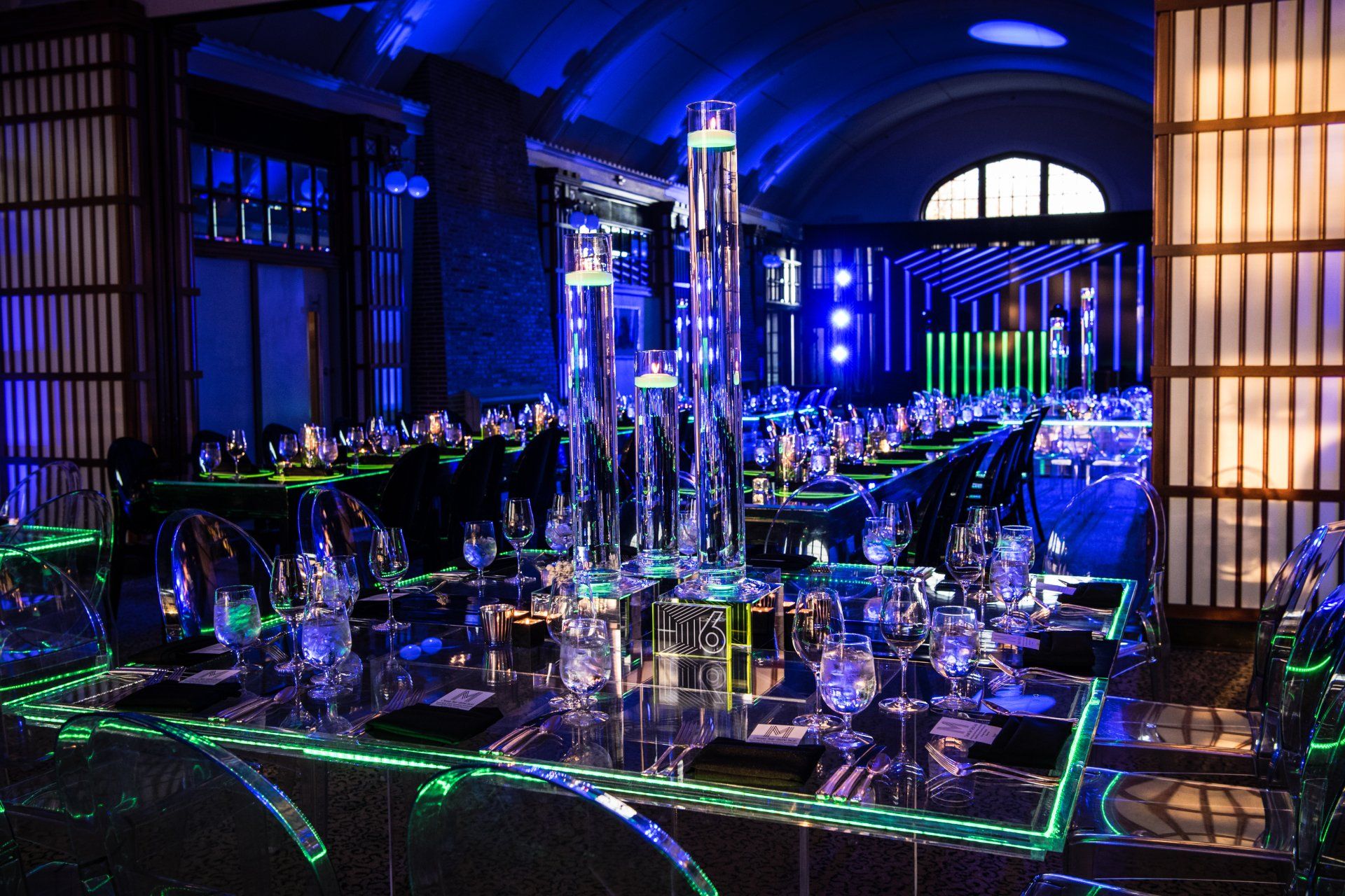 A table with a lot of glasses and candles on it