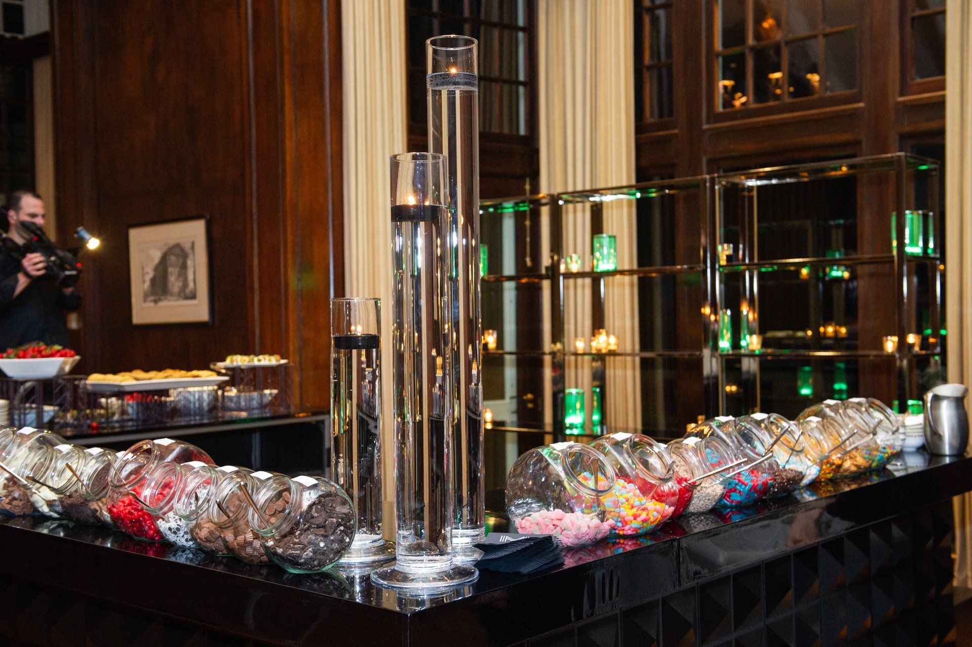 A buffet table with jars of candy on it