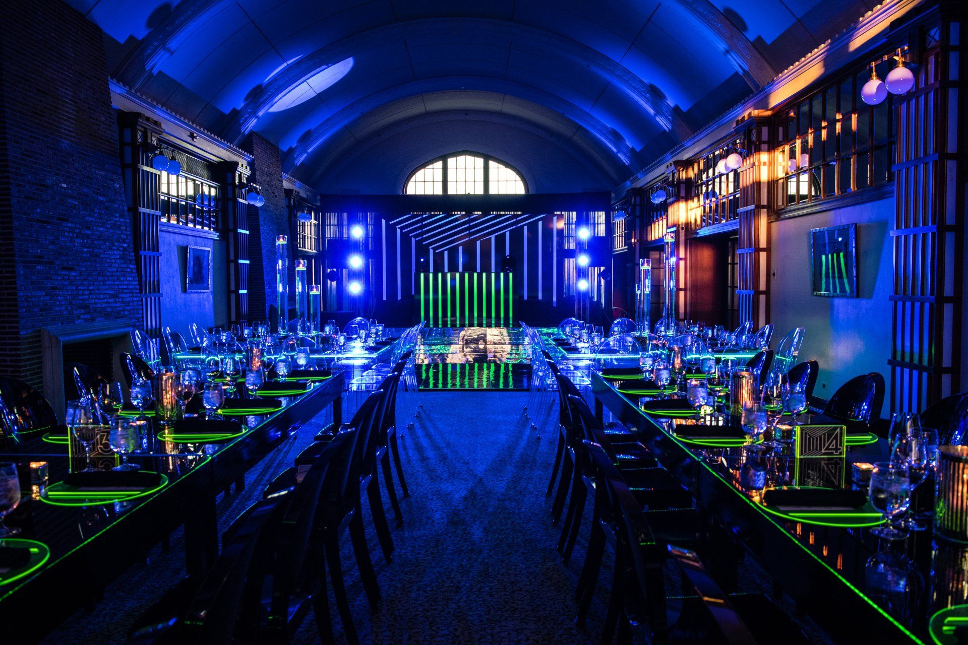 A large room with tables and chairs set up for a party.