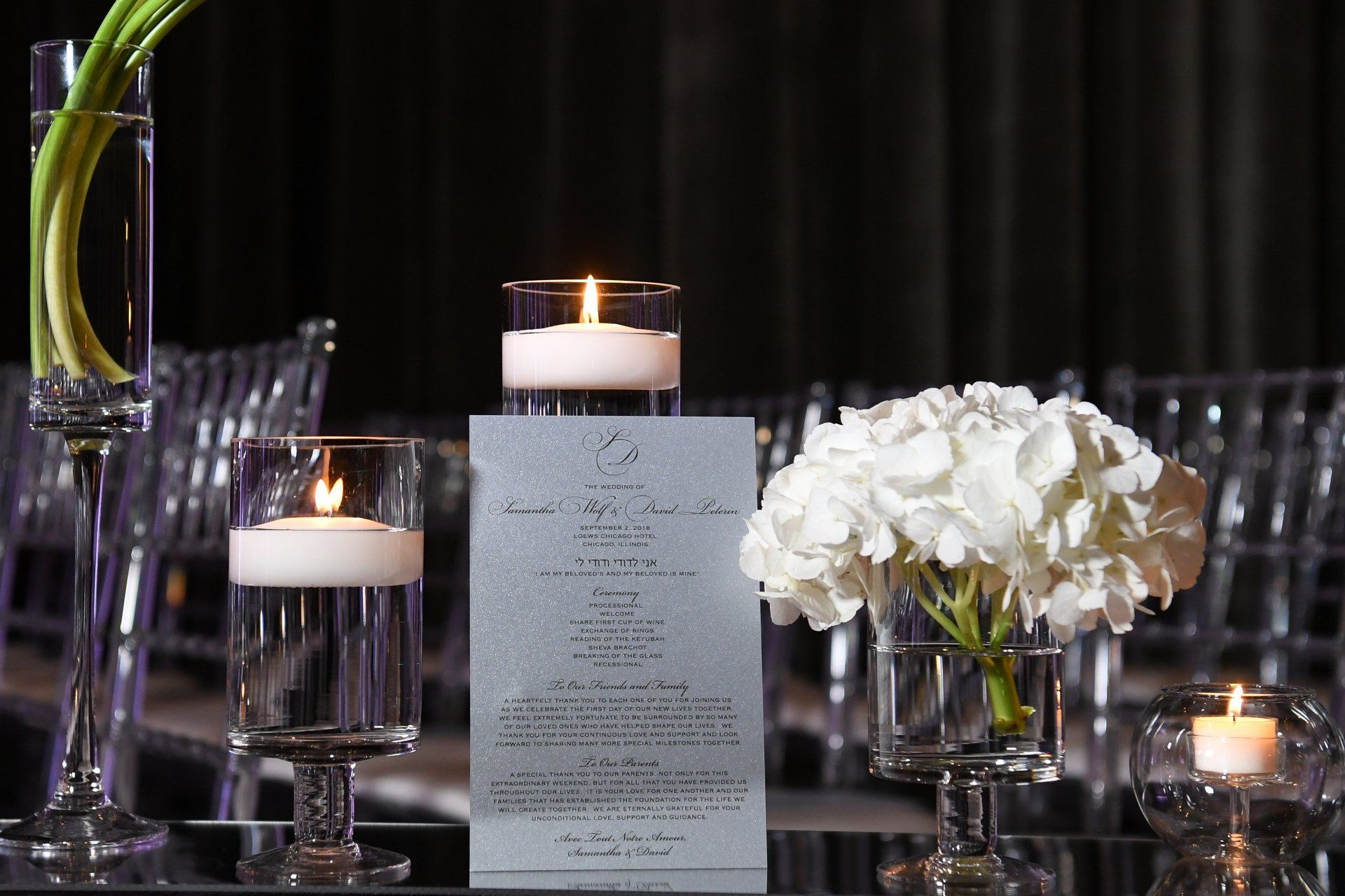 A table with a menu and candles on it