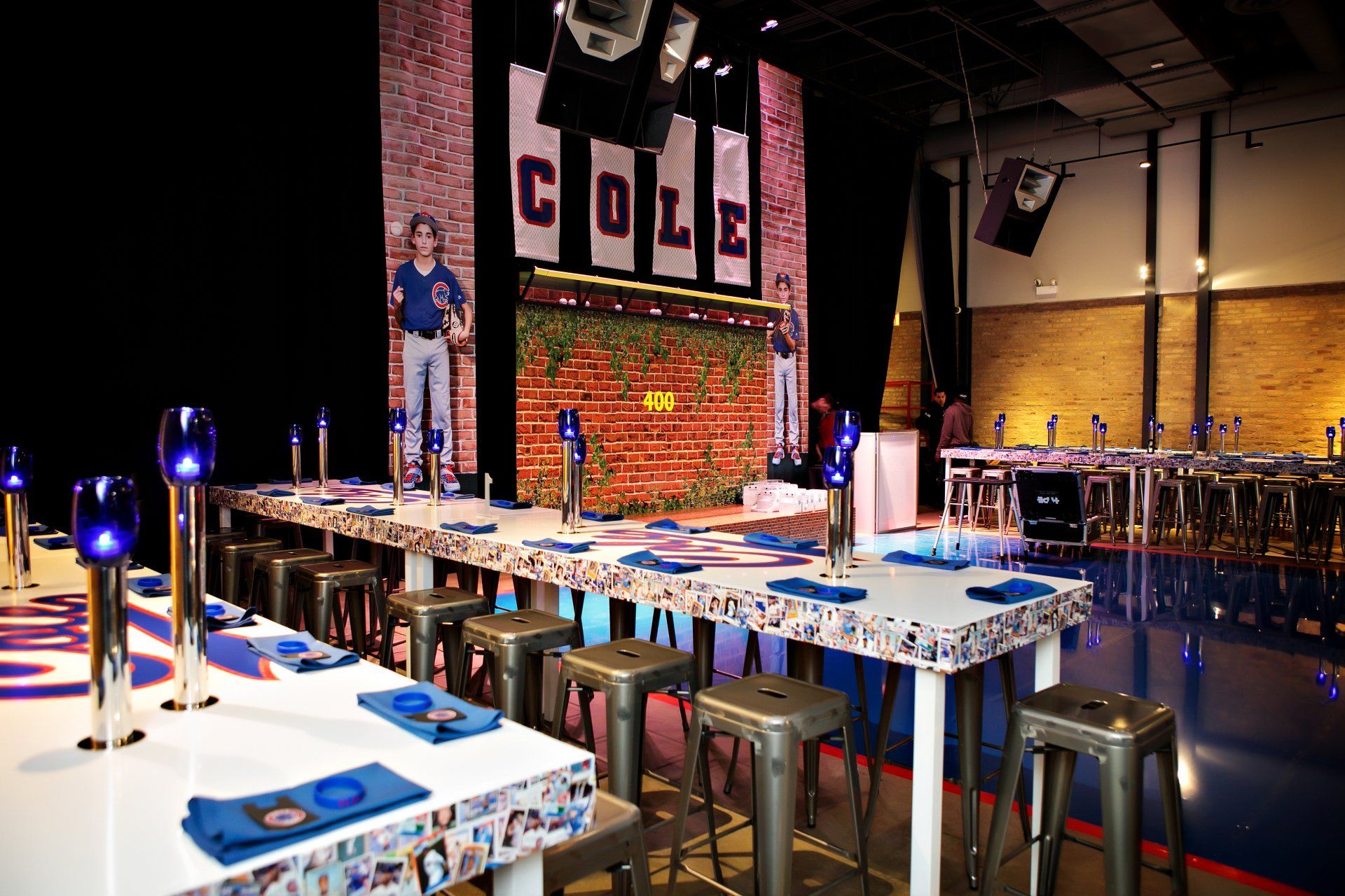 A large room with tables and stools and a sign that says cole