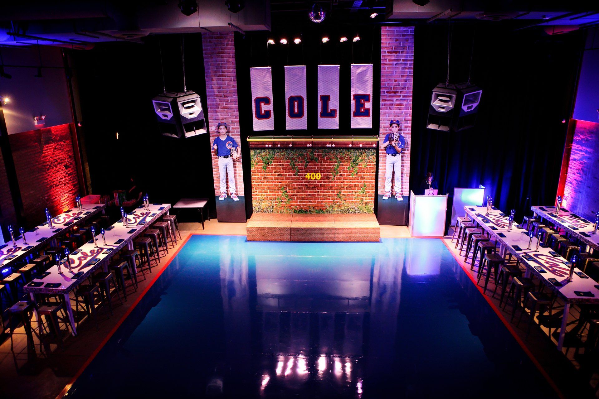 A large room with tables and chairs and the word cole on the wall