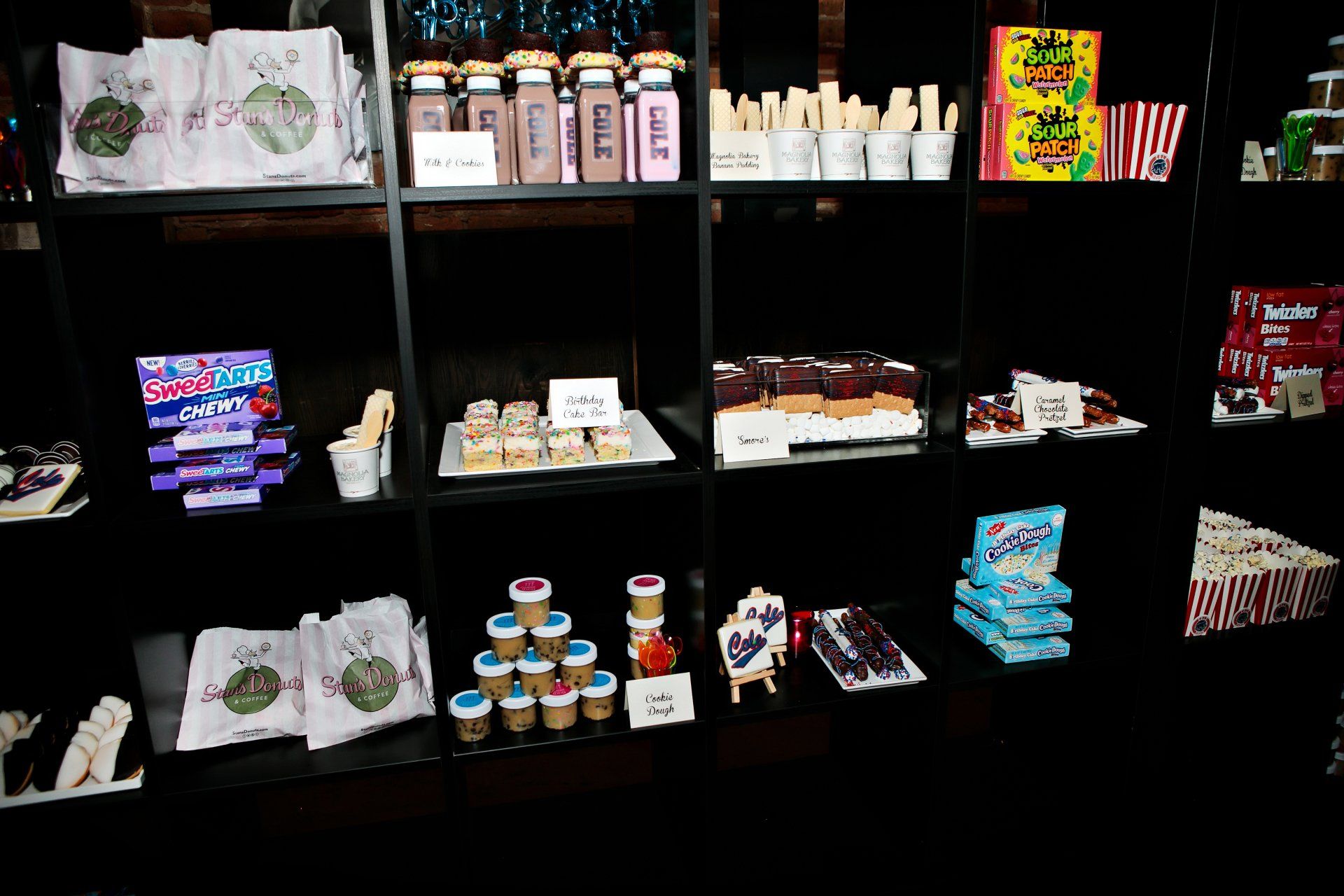 A shelf filled with a variety of items including candy