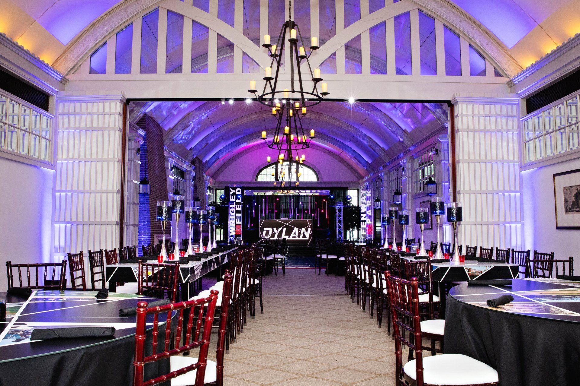 A large room with tables and chairs and a sign that says dylan