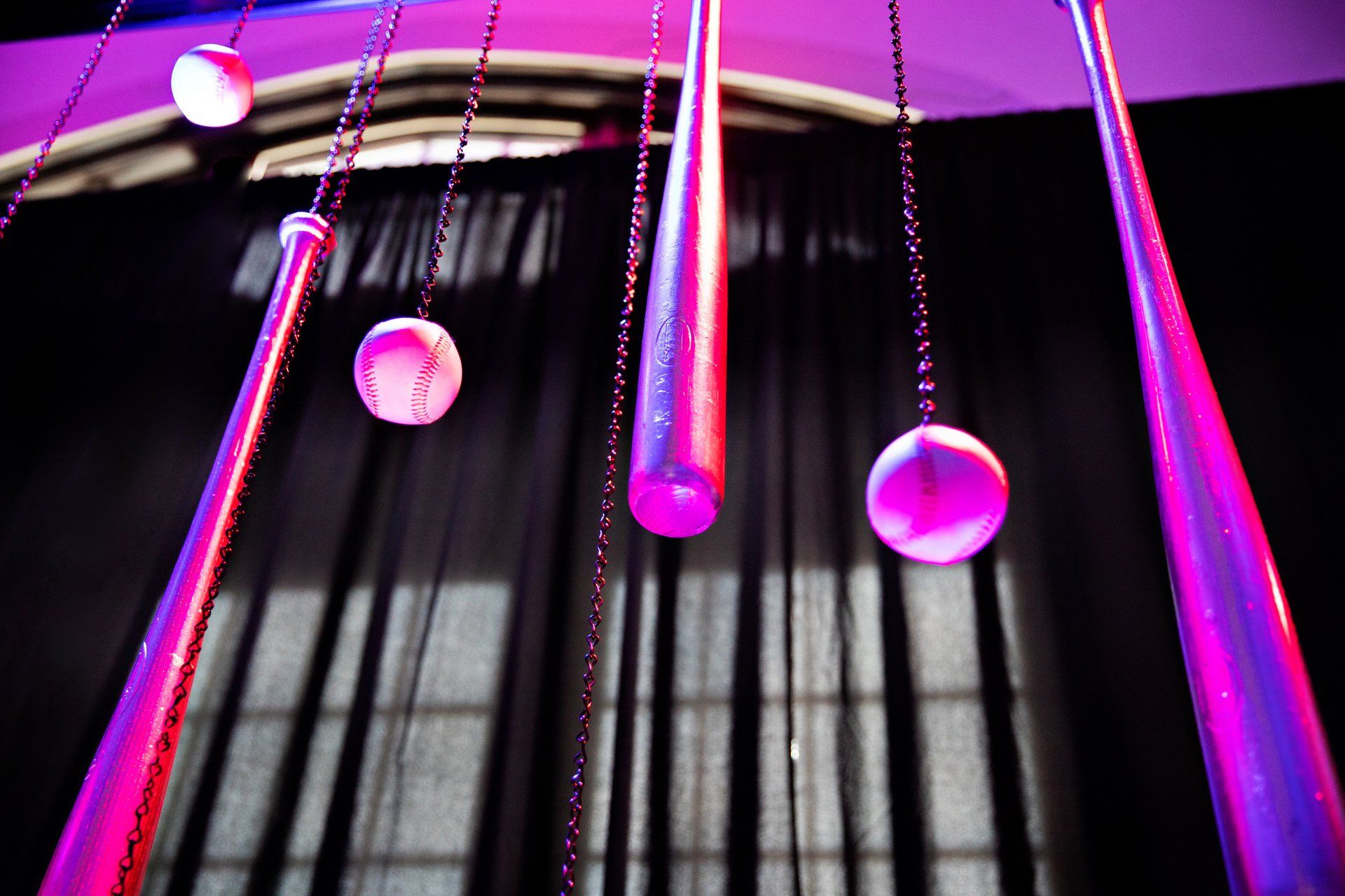 A bunch of purple lights hanging from the ceiling