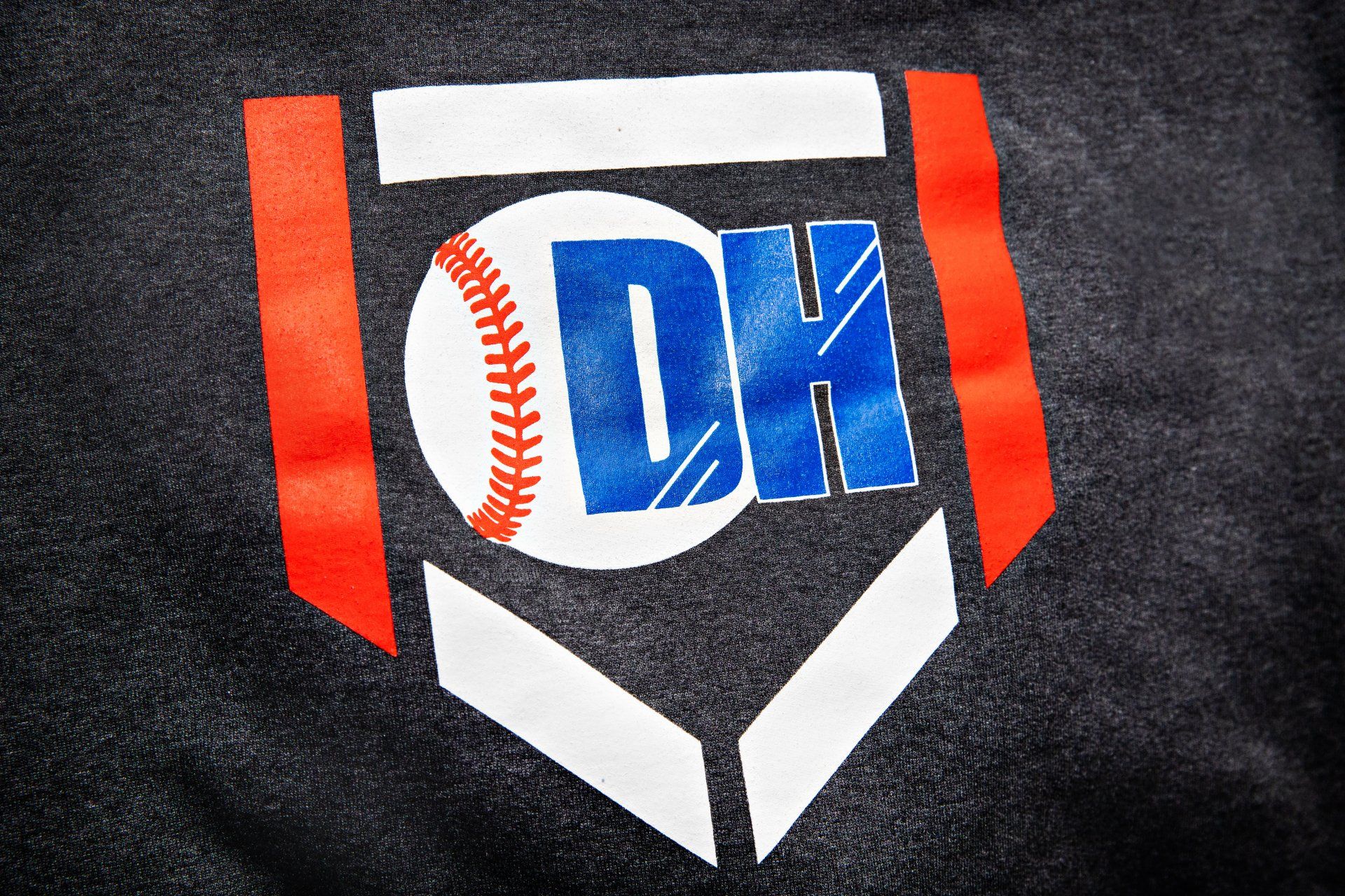 A black shirt with a baseball and the letter dk on it