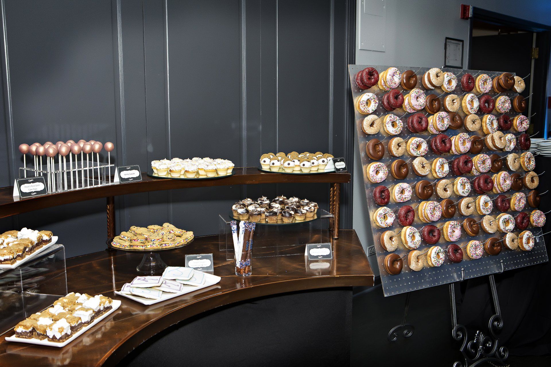 A buffet table with a wall of donuts on it