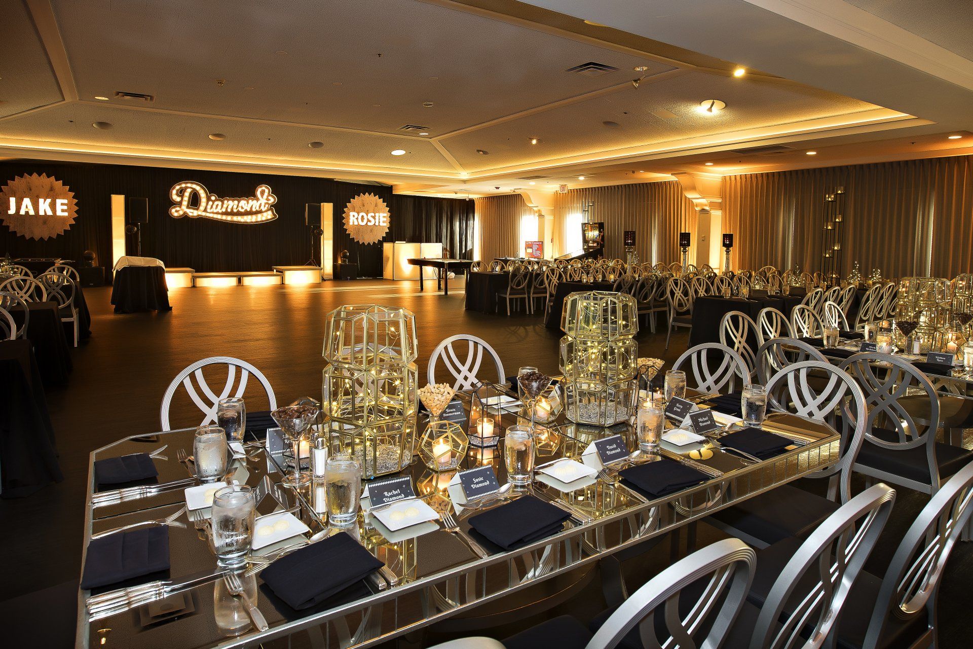 A large room with tables and chairs set up for a party.