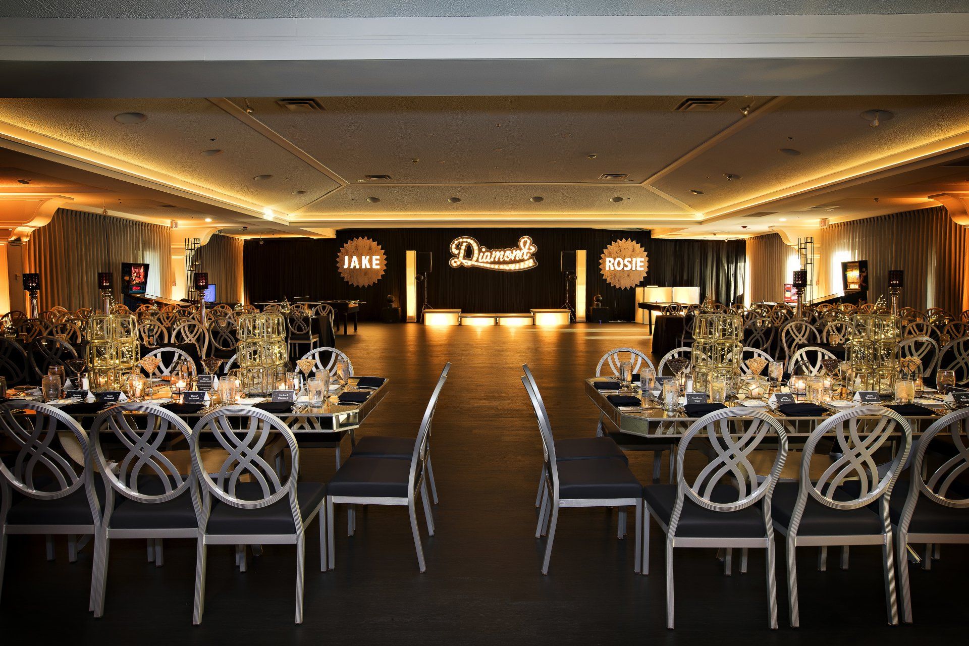 A large room with tables and chairs set up for a party