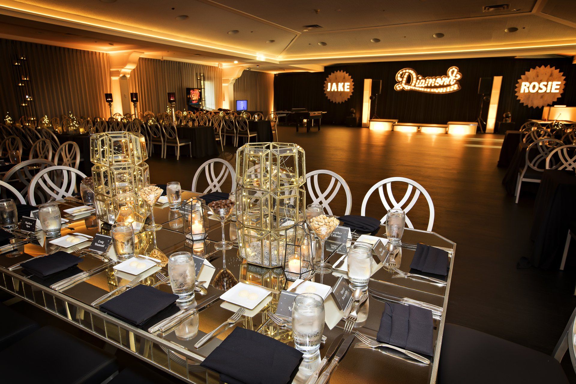 A large room with tables and chairs set up for a party.