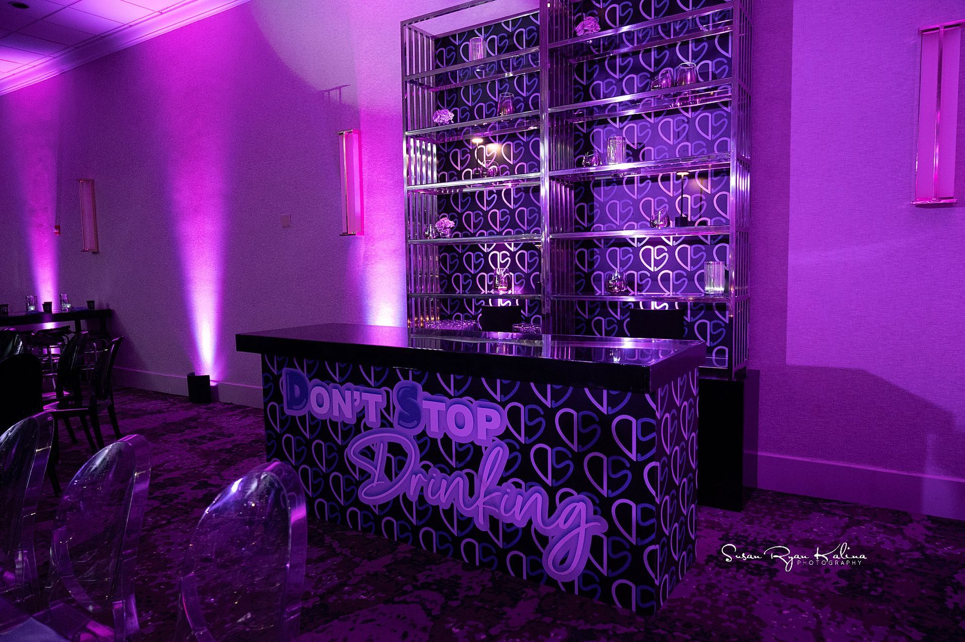 A purple room with a bar that says `` do n't top drinking ''