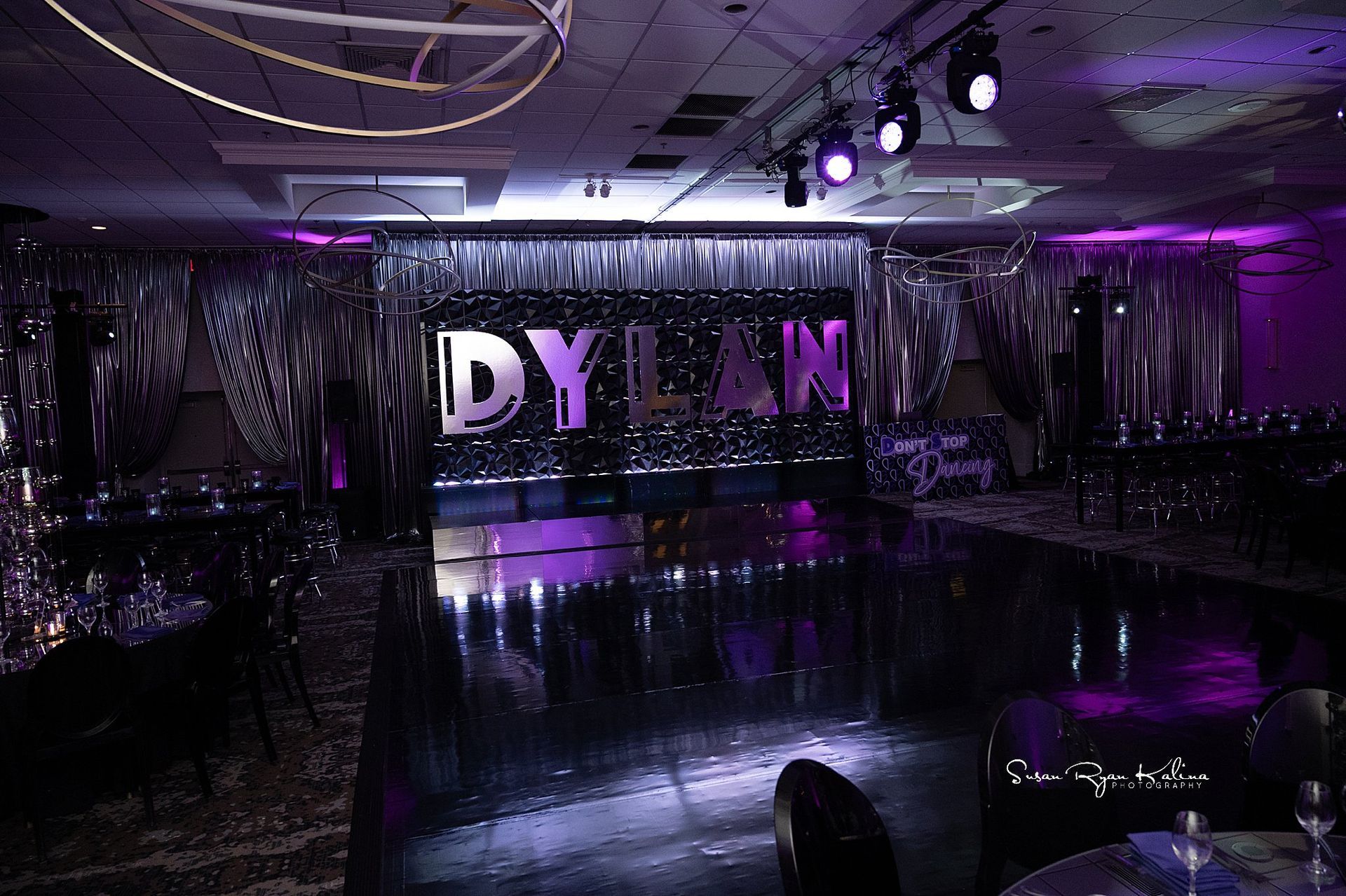 A large room with a dance floor and a sign that says dylan