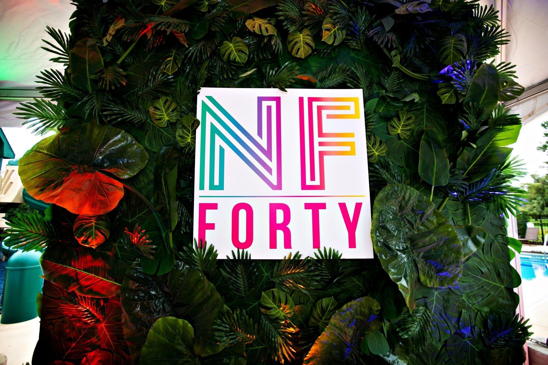 A sign that says nf forty is surrounded by plants.