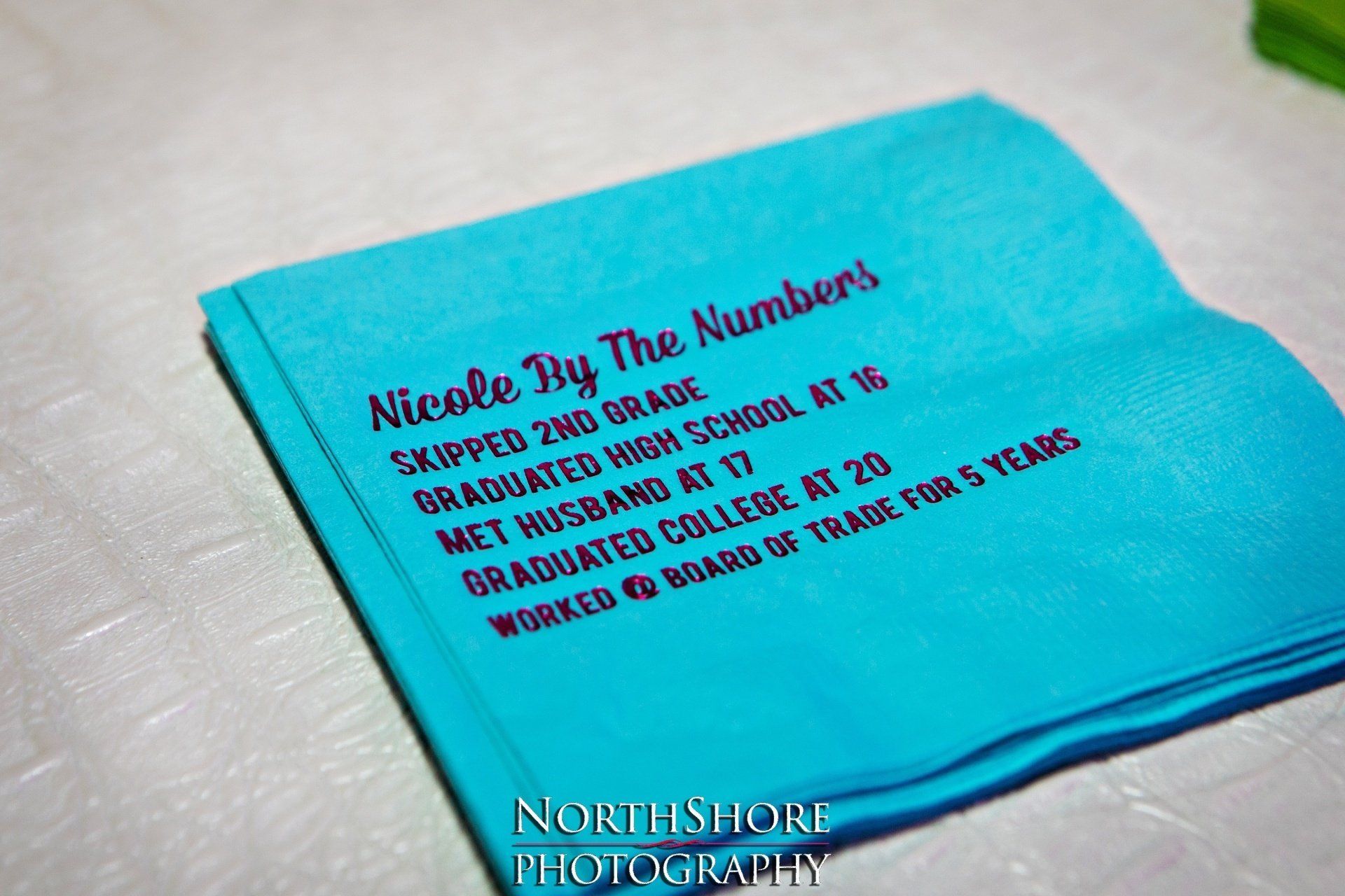 A blue napkin with nicole by the numbers written on it