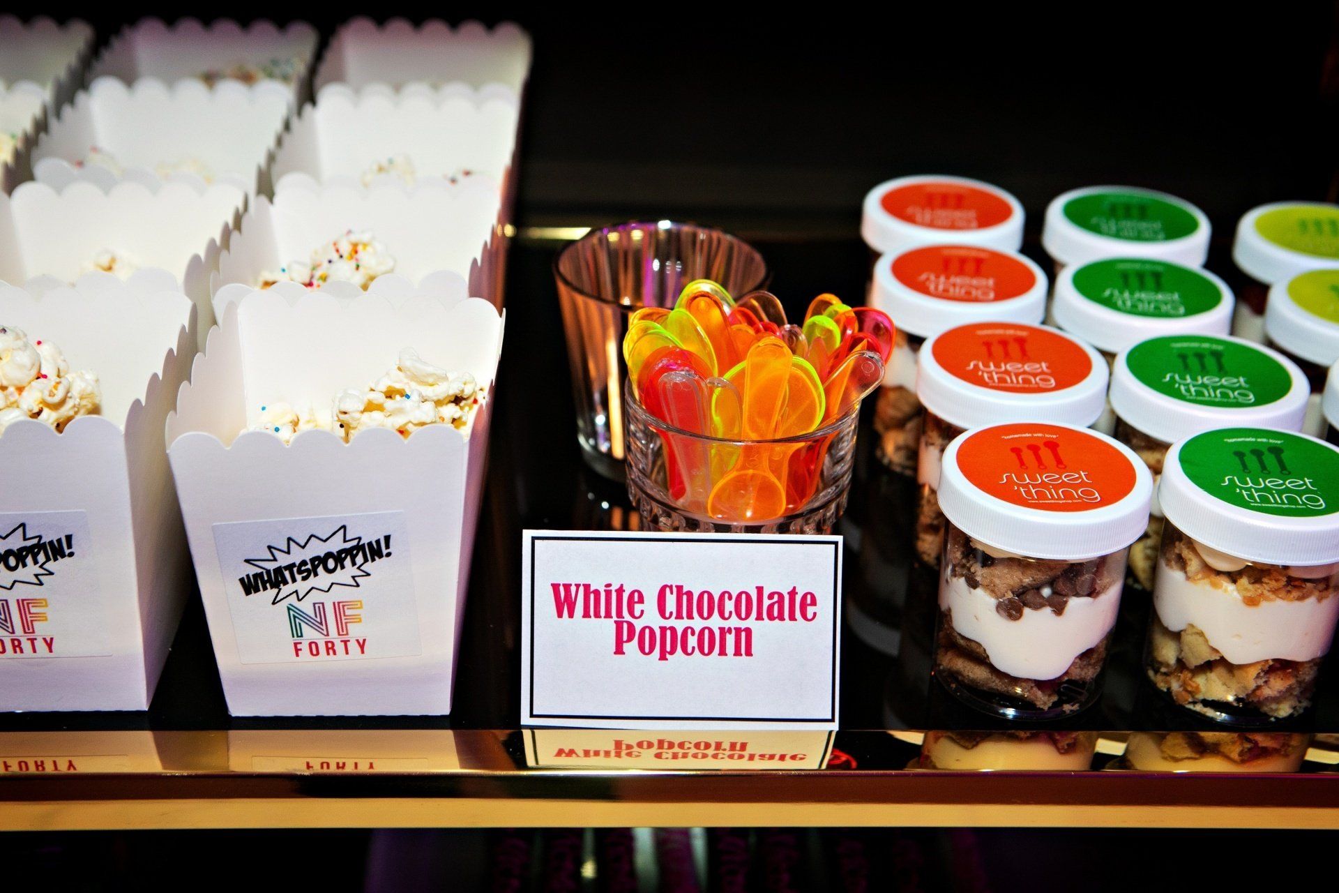 A sign that says white chocolate popcorn on it