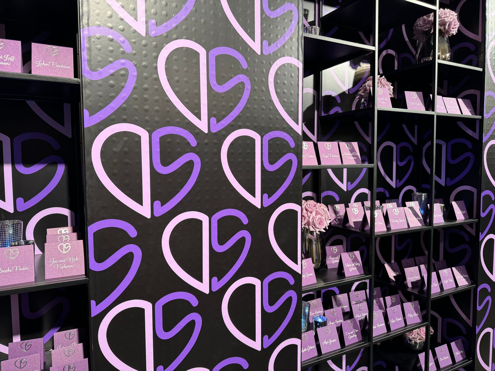 A wall with purple hearts painted on it